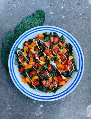 Deze super gezonde palmkool salade met zoete aardappel, gepofte tomaatjes en dressing van cashewnoten is volledig veganistisch én super smaakvol. Een feest op je bord en in je mond.